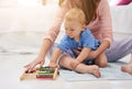 Mommy and her mini mathematician. Cropped shot of a mother and her baby boy counting on an abacus.