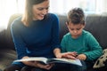 Sharing some special bonding time together. Cropped shot of a mother reading a book to her little son at home. Royalty Free Stock Photo