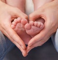 Loving the little things. Cropped shot of a mothers hands making a heart shape around her babys feet.
