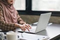 Cropped shot of Muslim millennial Asian businesswoman wearing a brown hijab hands using laptop computer working remotely Royalty Free Stock Photo