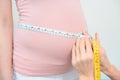 cropped shot of obstetrician gynecologist measuring belly size of pregnant woman with measuring tape Royalty Free Stock Photo