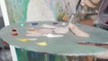 Cropped shot of a palette of a female painter