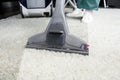 cropped shot of person cleaning white carpet with professional vacuum Royalty Free Stock Photo