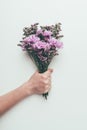 Cropped shot of person holding beautiful elegant bouquet of tender flowers