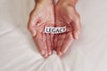 Whats your story. Cropped shot of a person holding a piece of paper with the word legacy written on it. Royalty Free Stock Photo