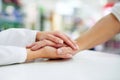 Kindness goes a long way towards healing. Cropped shot of a pharmacist compassionately holding a customers hand. Royalty Free Stock Photo