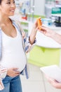 pharmacist giving pills to pregnant woman Royalty Free Stock Photo