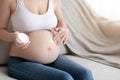 Cropped Shot Of Pregnant Woman Applying Moisturising Cream At Her Naked Belly