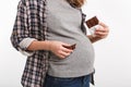 cropped shot of pregnant woman holding chocolate near belly Royalty Free Stock Photo