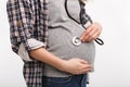 cropped shot of pregnant woman listening belly with stethoscope Royalty Free Stock Photo