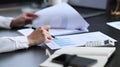 Cropped shot professional chartered accountant checking financial documents at her workplace Royalty Free Stock Photo