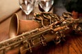 Cropped shot of saxophone and wine glasses Royalty Free Stock Photo