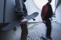 cropped shot of skateboarders in street outfit spending time