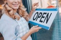 cropped shot of smiling cafe owner in apron holding Royalty Free Stock Photo