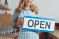 cropped shot of smiling waitress in apron holding Royalty Free Stock Photo