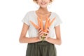 cropped shot of smiling young woman holding ripe carrots