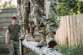 cropped shot of soldiers in military uniform practicing in obstacle run Royalty Free Stock Photo