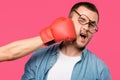 cropped shot of someone in boxing glove hitting man in eyeglasses isolated Royalty Free Stock Photo