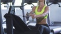 Cropped shot of a sportswoman exercising on seated cable row machine