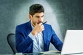 Shot of thinking businessman using laptop while sitting in the office and working Royalty Free Stock Photo