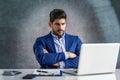 Shot of thinking businessman using laptop while sitting in the office and working Royalty Free Stock Photo