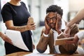 When stress gets the best of you. Cropped shot of a stressed out businessman surrounded by colleagues needing help in an