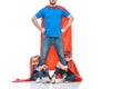 cropped shot of super dad standing with hands on waist while kids hugging his legs Royalty Free Stock Photo