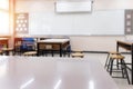 Cropped shot of table and copy space in blurred study room.Empty classroom or presentation room interior with desks Royalty Free Stock Photo