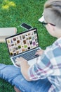 cropped shot of teenager using laptop with pinterest website while sitting