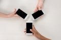 cropped shot of teenagers holding smartphones with blank screens Royalty Free Stock Photo