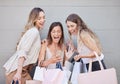 We have to get there now. Cropped shot of three attractive young women taking some time out to enjoy a shopping spree in Royalty Free Stock Photo