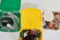 Cropped shot of three colorful green, yellow and white recycle garbage bins full of rubbish isolated on white background Royalty Free Stock Photo