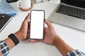 Cropped shot top view of businessman hands using smartphone mockup on office desk. Blank screen mobile phone for graphic display Royalty Free Stock Photo