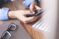 Cropped shot top view of businesswoman hands using smartphone mockup at the wooden office desk. Blank screen mobile phone for grap Royalty Free Stock Photo