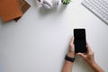 Cropped shot top view of hands using smartphone mockup at the white office desk. Blank screen mobile phone Royalty Free Stock Photo