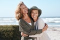 Best friends for life. Cropped shot of two attractive mature women hugging while standing on the beach. Royalty Free Stock Photo