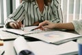 Two business colleagues checking financial reports together at office desk. Royalty Free Stock Photo