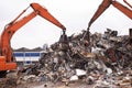 Industrial re-purposing. Cropped shot of two excavators sorting through a pile of scrap metal. Royalty Free Stock Photo