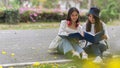 Cropped shot of two pretty female students outdoor studying together in campus ground Royalty Free Stock Photo