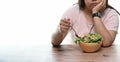 Cropped shot of an unhappy overweight woman bored of diets eating healthy food.