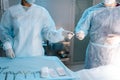 Cropped shot of unrecognizable assistant in surgical uniform assists surgeons, giving medical instruments during Royalty Free Stock Photo