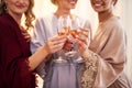 Cheers to the bride. Cropped shot of an unrecognizable bride and her bridesmaids making a toast with wineglasses in Royalty Free Stock Photo