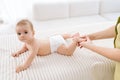 Cropped shot of unrecognizable female therapist doctor doing gymnastics and foot massage to adorable baby. Closeup hand Royalty Free Stock Photo