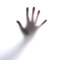 Trying to get out. Cropped shot of an unrecognizable persons hand against a seethrough film. Royalty Free Stock Photo