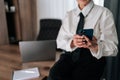 Cropped shot of unrecognizable successful business woman using typing smartphone searching info sitting on office desk Royalty Free Stock Photo