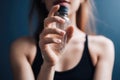 cropped shot of an unrecognizable woman holding up a plastic bottle with the cap on