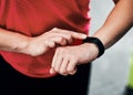 Monitoring her progress. Cropped shot of an unrecognizable young female athlete checking her smartwatch while working Royalty Free Stock Photo