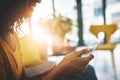 Sorting out her weekend plans. Cropped shot of an unrecognizable young woman using her cellphone while relaxing at home Royalty Free Stock Photo