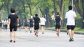 Cropped shot of view of back of people run and walk at pedestrian garden park