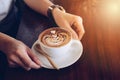 Cropped shot view of a cup of hot Mocha serving on wooden table. Royalty Free Stock Photo